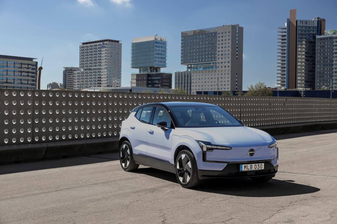 An electric compact car in a blue exterior image reflecting city-friendly maneuverability and design